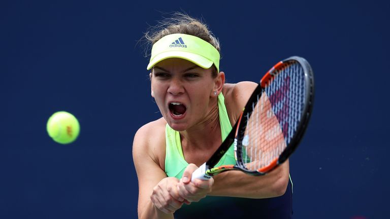 Simona Halep of Romania plays a shot against Angelique Kerber of Germany during the Rogers Cup