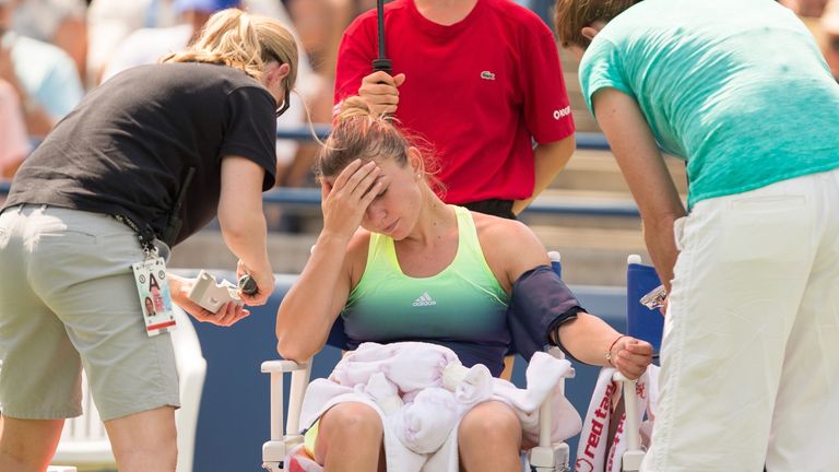 Simona Halep receives medical help during  her final against Belinda Bencic at the Rogers Cup in Toronto