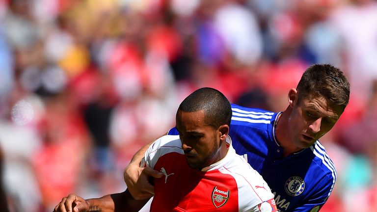 Chelsea's Gary Cahill (right) expects a strong bid from Theo Walcott (left) and his Arsenal team-mates for the Premier League title this season