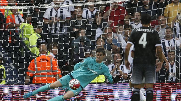Thibaut Courtois dives to save a James Morrison penalty