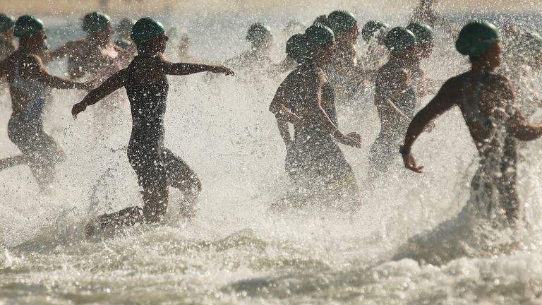 Female athletes enter the water on Copacabana  beach during the Triathlon on Sunday