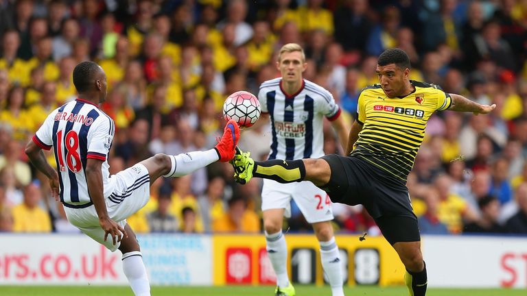 Troy Deeney of Watford and Saido Berahino of West Bromwich Albion  compete for the ball 