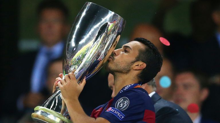Pedro of Barcelona  kisses the UEFA Super Cup trophy 