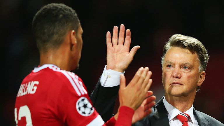 MANCHESTER, ENGLAND - AUGUST 18:  Louis van Gaal, manager of Manchester United celebrates victory with Chris Smalling after the UEFA Champions League Quali