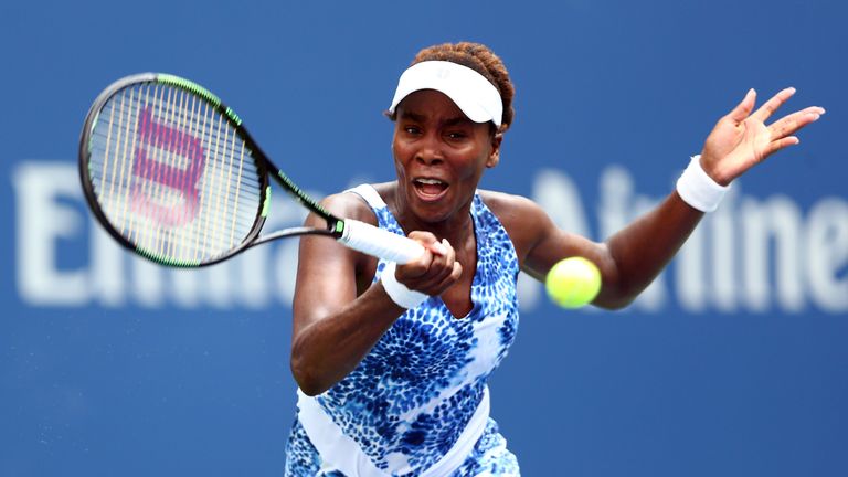 Venus Williams of the United States returns a shot against Monica Puig of Puerto Rico