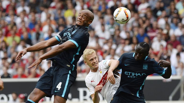 Stuttgart defender Timo Baumgartl (C) vies for the ball with Manchester City defender Vincent Kompany (L) and Bacary Sagna