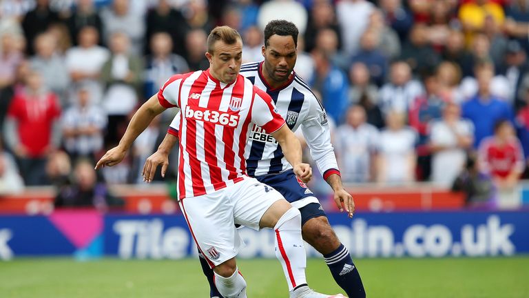 Xherdan Shaqiri of Stoke City and Joleon Lescott of West Bromwich Albion compete for the ball during the Barclays Prem