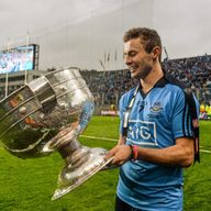 Jack McCaffrey celebrates in front of Hill 16 with the Sam Maguire Cup