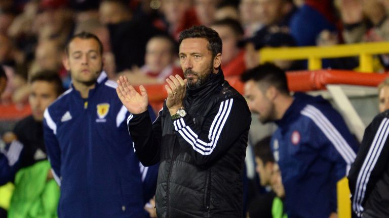 Aberdeen manager Derek McInnes applauds his side from the touchline 