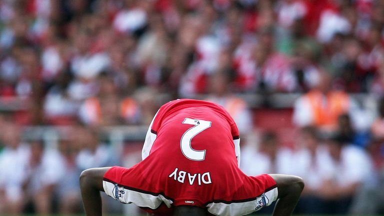 Arsenal's French midfielder Abou Diaby goes down injured during the Premier League football match between Arsenal and Portsmouth at The Emirates stadium in