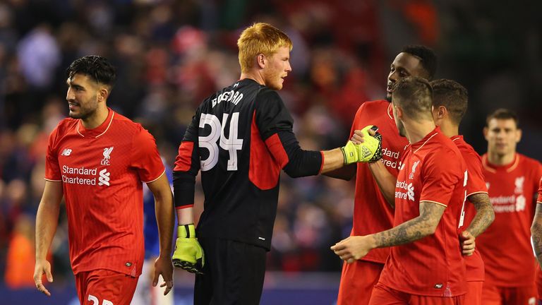 Adam Bogdan of Liverpool celebrates with team mates after saving the crucial penalty against Carlisle