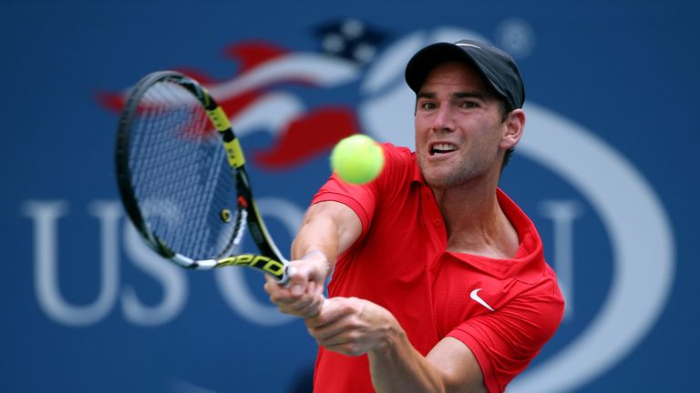 Adrian Mannarino of France returns a shot to Andy Murray of Great Britain during their Men's Singles Second Round match on Da