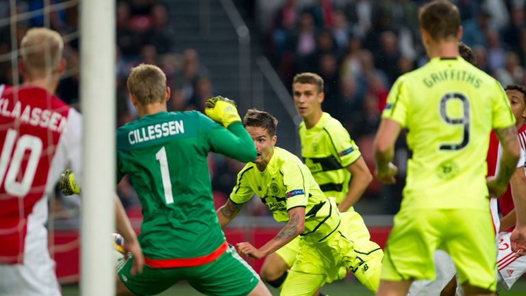Celtic's Mikael Lustig, center, scores during the Europe League Group A soccer match between Ajax Amsterdam and Celtic 