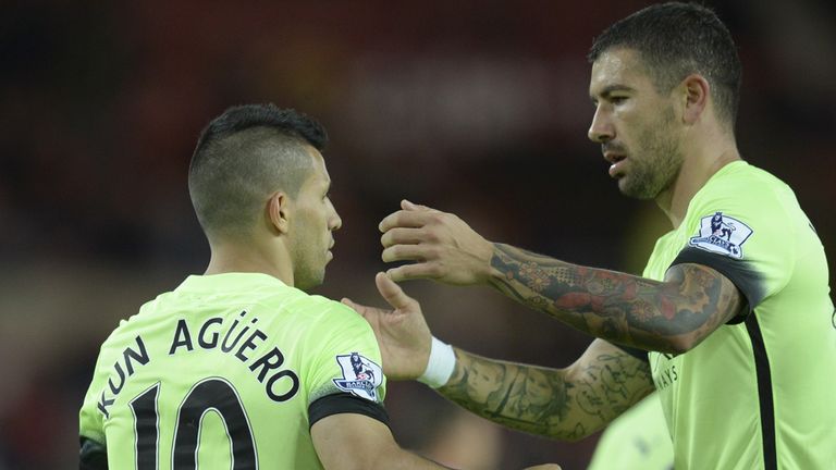 Manchester City's Argentinian striker Sergio Aguero (L) celebrates scoring the opening goal from the penalty spot with Aleksandar Kolarov