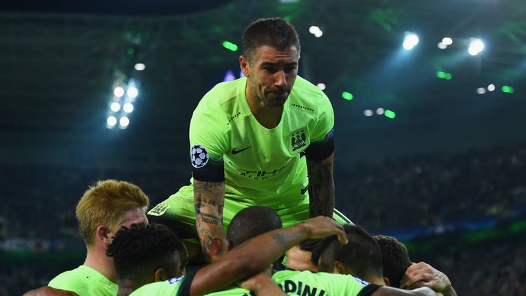 Aleksandar Kolarov of Manchester City (top) jumps on team mates as they celebrate 
