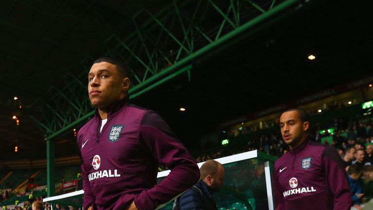 Alex Oxlade-Chamberlain and Theo Walcott of England  head out to warm up ahead of the International Friendly between Scotland and England