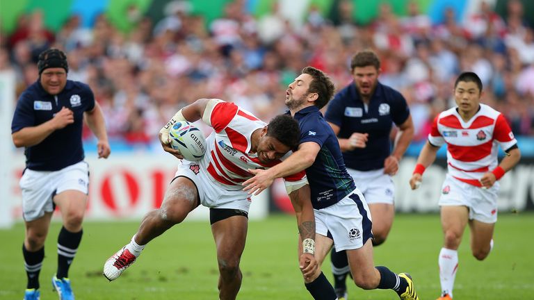 Amanaki Mafi of Japan is tackled by Greig Laidlaw of Scotland