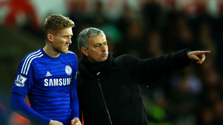 Jose Mourinho, manager of Chelsea speaks with Andre Schurrle