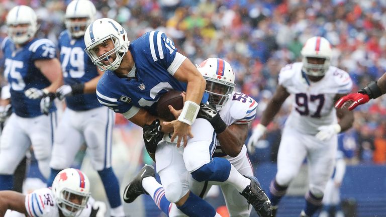 Andrew Luck #12 of the Indianapolis Colts is chased down by  Jerry Hughes #55 of the Buffalo Bills during the second half