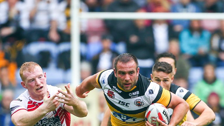 Castleford's Andy Lynch makes a break from Wigan's Liam Farrell.