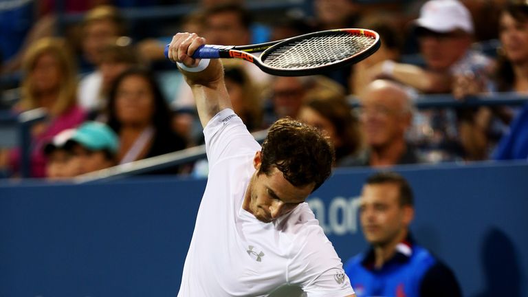Andy Murray of Great Britain breaks his racket while playing against Kevin Anderson of South Africa during their Men's Single