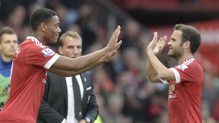 Manchester United's French striker Anthony Martial (L) comes on as a substitute for midfielder Juan Mata