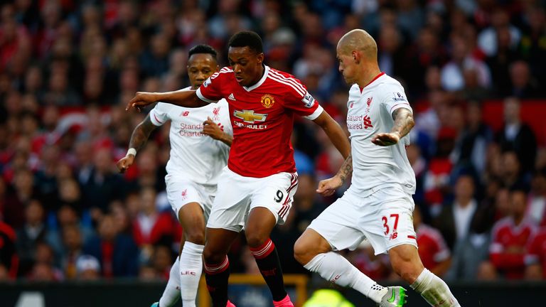 Anthony Martial of Manchester United takes on Nathaniel Clyne (L) and Martin Skrtel of Liverpool during the Barclays Premier League match at Old Trafford