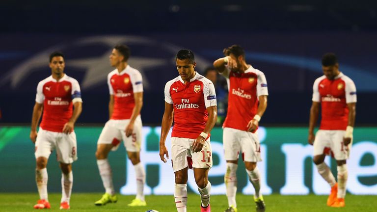 Alexis Sanchez of Arsenal looks dejected with team-mates