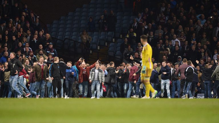 Fans invade the pitch as Aston Villa's Scott Sinclair scores their second goal during the FA Cup Quarter Final match against West Brom.