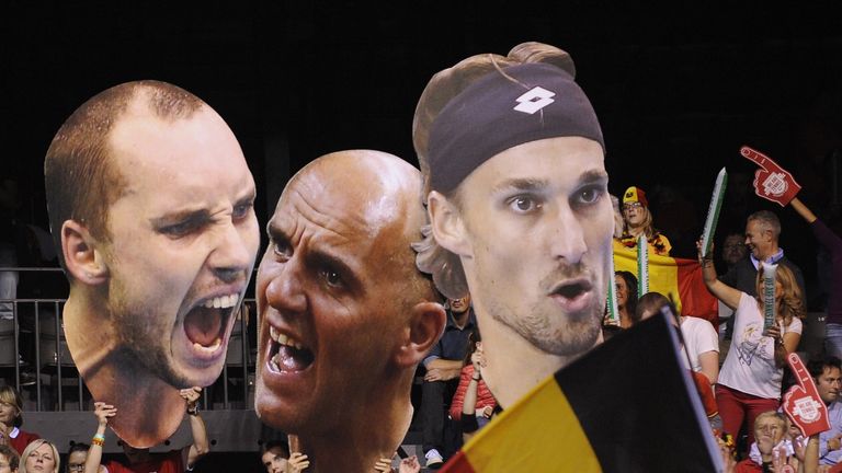 Supporters hold giant pictures of players of the Belgian tennis team (L-R) Steve Darcis, Ruben Bemelmans, Johan Van Herck 