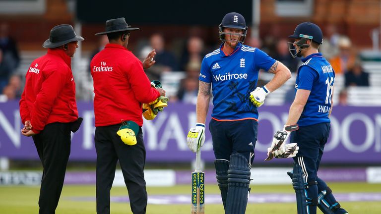 Ben Stokes of England waits for the decision of his wicket as Eoin Morgan of England watches