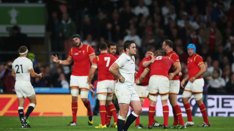 Brad Barritt of England looks dejected as the Wales team celebrates victory on the final whistle during the 2015 Rugby World Cup Pool A match at Twickenham