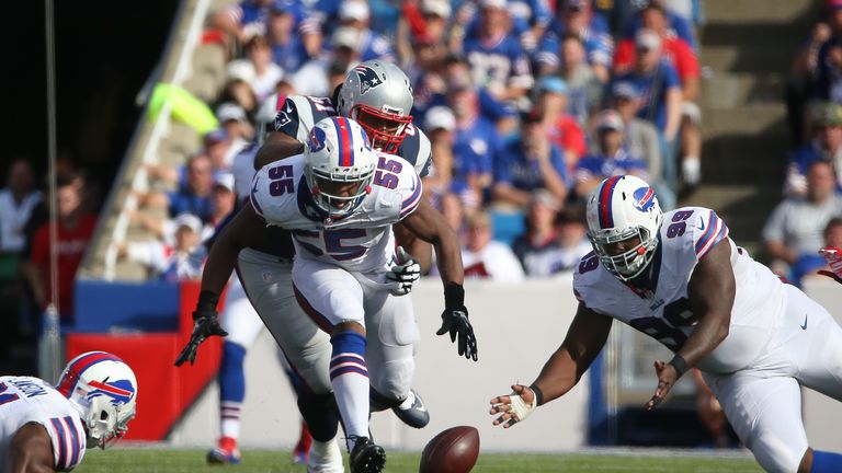 ORCHARD PARK, NY - SEPTEMBER 20: Jerry Hughes #55 of the Buffalo Bills causes a fumble as Marcell Dareus #99 tries to recover the loose ball during NFL gam