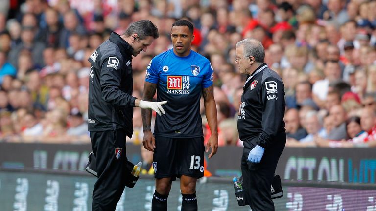 Callum Wilson of Bournemouth talks with medical staffs on the sideline during the Barclays Premier League match at Stoke City