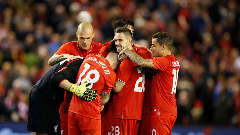 Liverpool goalkeeper Adam Bogdan (left) is congratulated by teammates after winning on penalties