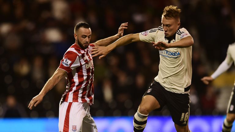 Cauley Woodrow of Fulham is tackled by Marc Wilson of Stoke City during the Capital One Cup Third Round match between Fulha