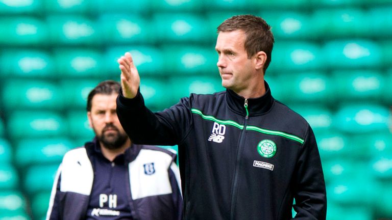 Celtic manager Ronny Deila stands in the dugout alongside Dundee counterpart Paul Hartley