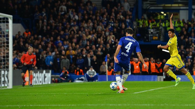 Maccabi Tel Aviv midfielder Dor Peretz (R) call for off-side as Chelsea's Cesc Fabregas (C) shoots to score his team's fourth goal