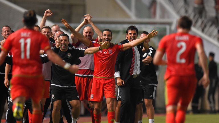Wales striker Gareth Bale runs over to the bench to celebrate after scoring the opening goal 