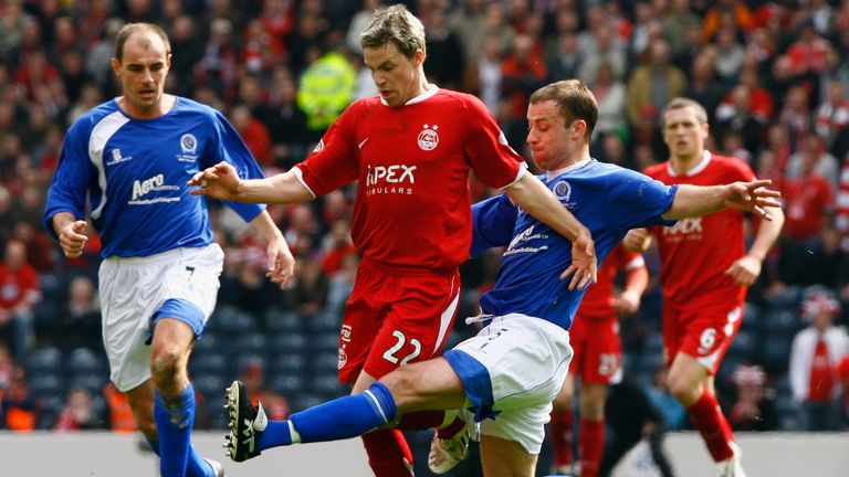 Andy Aitken of Queen of the South tackles Chris Maguire of Aberdeen during the Scottish Cup Semi Final between Queen of the South