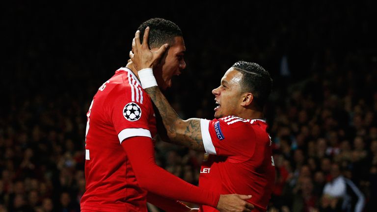 Chris Smalling of Manchester United (L) celebrates with team-mate Memphis Depay 