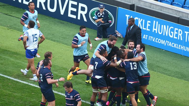 Chris Wyles of the United States is mobbed by team mates after scoring his teams opening try verses Samoa.