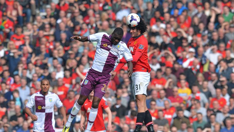 Manchester United's Belgian midfielder Marouane Fellaini (R) wins a header against Aston Villa's Zaire-born Belgian striker Christian Benteke (L) in 2014