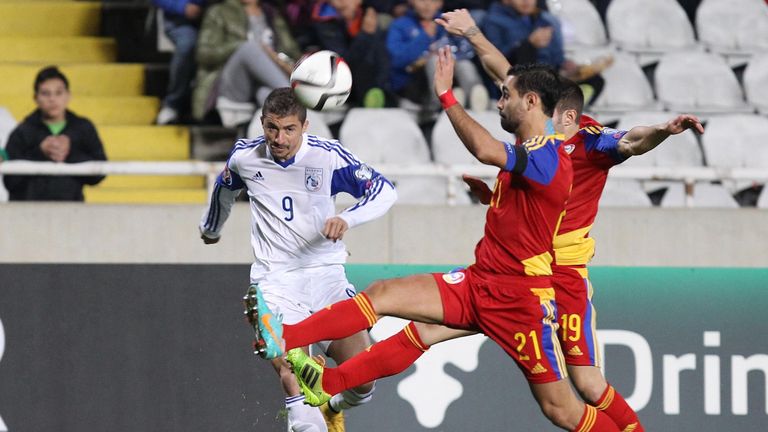 Cypriot player Dimitris Christofi (L) looks on as Andorra's Marc Garcia (21) and Ivan Lorenzo chase the ball during their Euro 2016 Group B qualifying matc