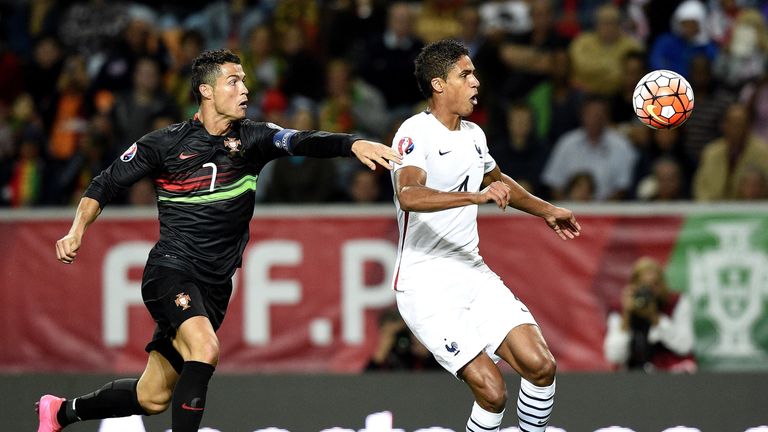 Portugal's Cristiano Ronaldo (L) vies with France's Raphael Varane 