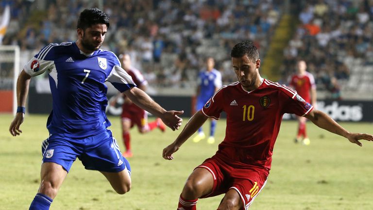 Belgium's Eden Hazard (R) dribbles the ball as Cyprus' Georgios Economides defends