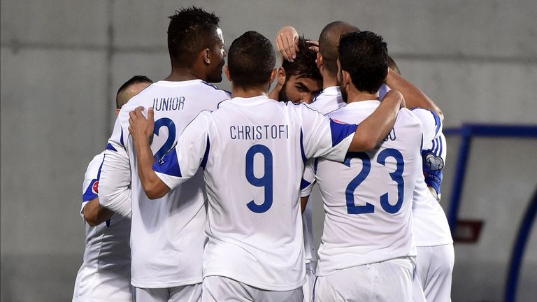 Cyprus' forward Nestor Mytidis (C) celebrates with teammates 