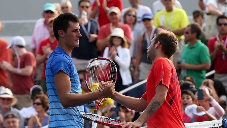 Dan Evans of Great Britain shakes hands at the net with Bernard Tomic of Australia after their US Open match