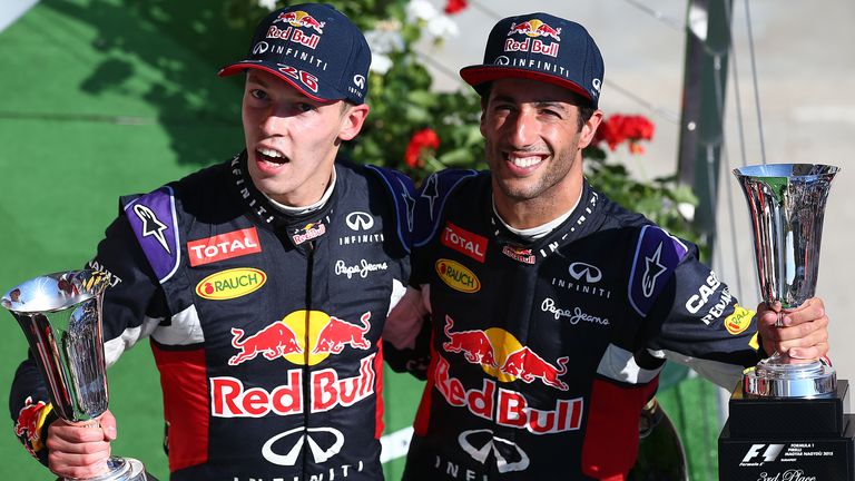 Daniel Ricciardo and Daniil Kvyat of Russia celebrate on the podium after finsihing third and second