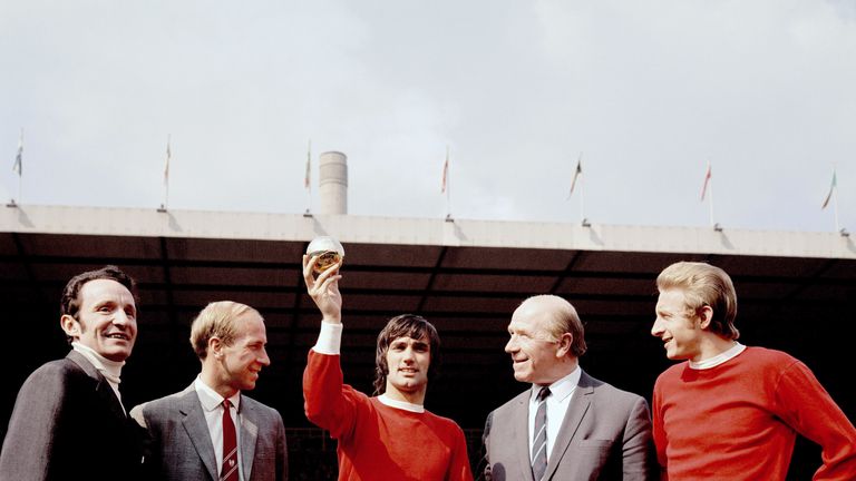 Manchester United's George Best (c) shows off the 1968 European Footballer of the Year award as Bobby Charlton, Matt Busby and Denis Law look on